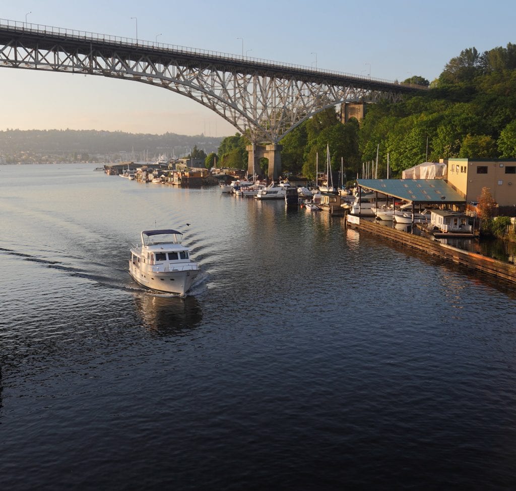 A boat passing under the Aurora Bridge as it leaves Lake Union in Seattle, WA