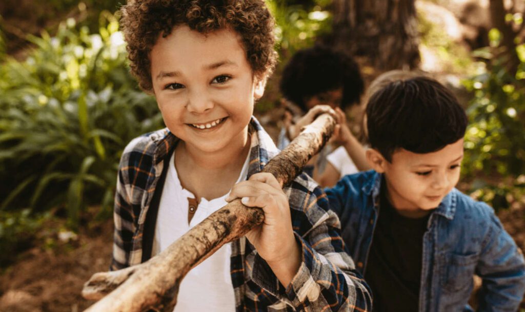 boys carrying stick